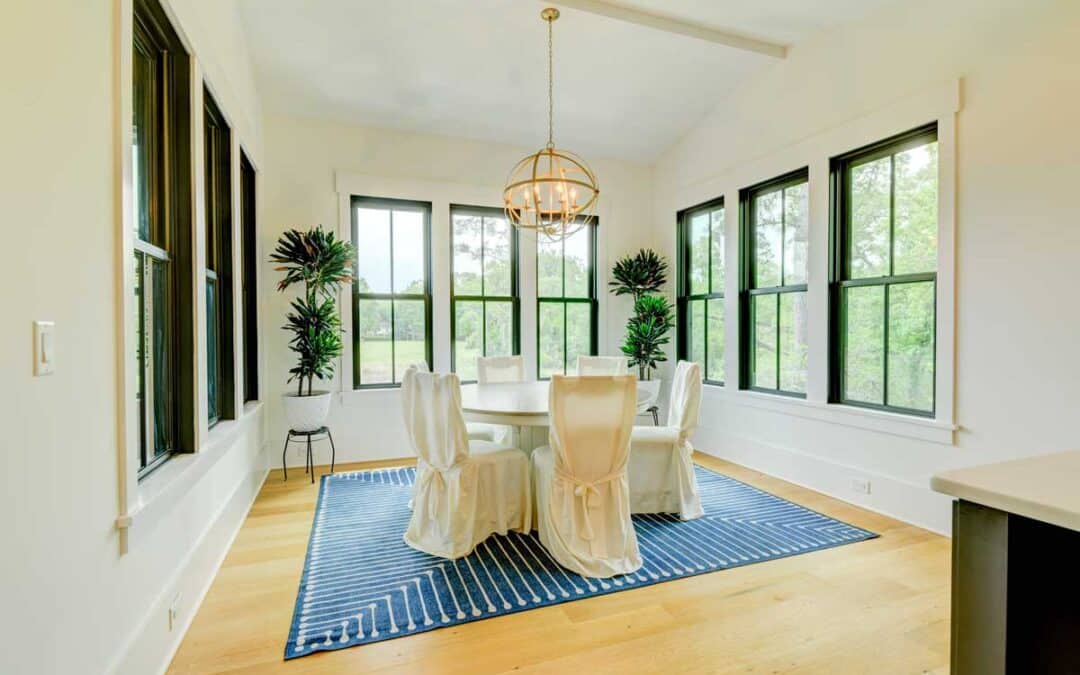 This dining area is surrounded by windows on 3 sides for natural light and views of nature