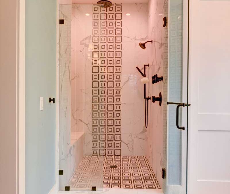 Custom shower featuring marble and custom tilework